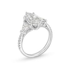 an engagement ring with three pear shaped diamonds on the sides and side stones in the center