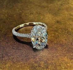 an oval cut diamond ring on a table