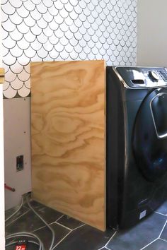 a washer and dryer sitting next to each other in a room with tile flooring