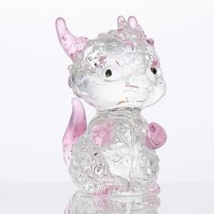 a glass cat figurine sitting on top of a table