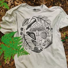 Forest Floor T-Shirt Heather Grey Cotton T-shirt With Graphic Print, Heather Grey Graphic Print Cotton T-shirt, Heather Grey Cotton Graphic T-shirt, Heather Grey Graphic Print T-shirt For Streetwear, Heather Grey Tri-blend T-shirt With Graphic Print, Heather Grey Tri-blend T-shirt With Screen Print, Casual Heather Grey T-shirt With Graphic Print, Gray Custom Print T-shirt For Streetwear, Heather Grey Graphic Tee With Graphic Print