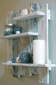 a wooden shelf with two shelves on top of it and a candle in the middle