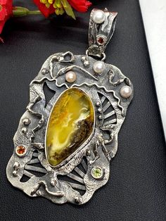 "Hand-made Sterling Silver 925 Stones used: Baltic Amber, Pearls, Peridot, Garnet Height - 3 3/8\" (with bail), Width - 1 3/4\" Unique Handcrafted One-of a-kind Design Pendant Each Piece of Jewelry in my Collection is Absolutely One of a Kind! When you start wearing a piece of my jewelry you will fall in love with it more and more each day and feel that good Energy and Love that I pass into it while creating this piece of Art. A piece of Art created for you to be inspired and love it through all Artisan Jewelry With Rectangular Pendant For Gift, Handmade Amber Necklace For Anniversary, Unique Sterling Silver Gemstones For Gifts, Fusion Style Pendant Jewelry As A Gift, Fusion Style Pendant Jewelry For Gifts, Handmade Sterling Silver Fusion Jewelry, Artisan Jewelry With Stones As A Gift, Exquisite Silver Jewelry With Large Pendant, Fusion Style Pendant Jewelry Gift