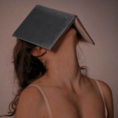 a woman with a book on her head