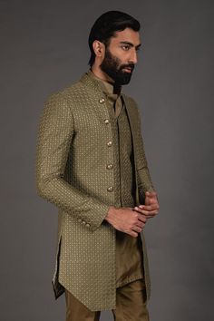 Olive green front open achkan with embroidered detail and full sleeves. Paired with shirt style kurta and lounge pant.
Component: 3
Pattern: Embroidered
Neckline: Mandarin
Sleeve Type: Full Sleeves
Fabric: Chanderi Silk, Cotton Silk
Color: Green
Other Details: 
Silk thread work
Front buttons
Printed lining
Note: Waistcoat worn by the model is not for sale
Occasion: Sangeet - Aza Fashions Traditional Zari Work Sets For Semi-formal Occasions, Formal Green Kurta With Chikankari Embroidery, Green Fitted Kurta With Naqshi, Pista Green Nehru Jacket For Designer Wear, Green Bandhgala With Chikankari Embroidery For Eid, Fitted Green Bandhgala With Naqshi Detailing, Fitted Green Bandhgala With Naqshi, Designer Green Kurta For Festive Occasions, Designer Sets With Resham Embroidery And Long Sleeve