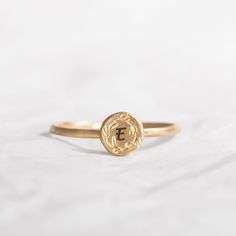 This gorgeous Solid 14K custom initial ring, is engraved with dainty handmade floral decoration. A special gift ring to cherish for many years to come, the top gold disk is engraved with a single letter but you choose to engrave any other word in the following link: https://etsy.me/2HCG2W2 A perfect gift idea for your graduation or birthday gift. Band width: 1.2 mm / 0.05' Inch, band thickness: 0.8 mm / 0.03' Inch Top ring diameter 6 mm / 0.24' Inch *Each extra letter cost $2 - Please add the at Wreath Crown, Custom Wedding Band, Engraved Initials, Top Rings, Floral Ring, Single Letter, Initial Ring, Floral Decoration, Custom Initials