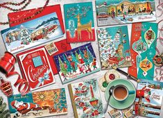 many christmas cards are on the table with a cup of coffee