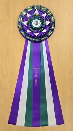 The Glastonbury 32" Champion Award Rosette Ribbon is completely customizable. It comes standard with custom printing on the center streamer, custom laser printed logo on the center button and you choose the colors. For more information, please call McLaughlin Ribbon Awards at (919) 934-1344 or email info@mclaughlinribbonawards.com #awardribbons #customawardribbons #rosettes #rosetteribbons #awards #necksashes #horseshowribbons #dogshowribbons #catshowribbons #livestockshowribbons