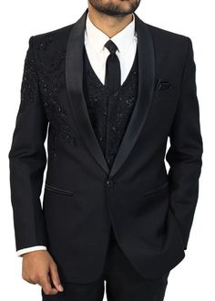 Elevate your style and dress to rule with our Designer Black Shawl Lapel Hand-Embroidered 6-Piece Tuxedo Suit for Men. This exceptional ensemble is more than just clothing; it's a true masterpiece that defines elegance and luxury. The sleek black shawl lapel of the jacket exudes an air of sophistication and refinement, while the intricate hand embroidery elevates the suit to a realm of its own. Crafted with meticulous attention to detail, every stitch and embellishment reflects the artistry that went into creating this work of sartorial excellence. Perfectly suited for formal occasions and special events, this suit ensures that all eyes are on you, making you the undisputed center of attention wherever you go. It's not just a tuxedo; it's a statement, a bold proclamation of your timeless y Embellished Notch Lapel Suits For Semi-formal Occasions, Designer Fitted Sets With Suit Collar, Embellished Tuxedo Sets For Formal Occasions, Designer Tailored Embellished Sets, Black Fitted Sets For Ceremony, Fitted Embellished Tuxedo For Black-tie Events, Festive Fitted Three-piece Suit With Notch Lapel, Designer Fitted Suit For Ceremony, Semi-formal Embellished Notch Lapel Suits