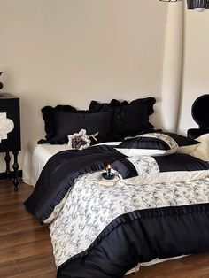 a black and white bed in a bedroom