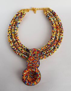 This necklace is 100% handcrafted using multi color beads. Perfect for African themed events. Measurements; 20 inches 18 inches(middle strand) 16 inches. 4 inch pendant. More neckleces here; https://www.etsy.com/shop/TribalTess?ref=seller-platform-mcnav&section_id=21306083 Back to my shop; https://www.etsy.com/shop/TribalTess?ref=seller-platform-mcnav Unique Multi-strand Colorful Beaded Necklaces, Double Strand Polished Bead Necklaces, Double Strand Polished Beads Necklace, Colorful Double Strand Beaded Necklaces, Multicolor Small Beads Multi-strand Jewelry, Unique Double Strand Colorful Beaded Necklaces, Unique Multicolor Double Strand Necklace, Pendant Beaded Necklaces With Colorful Beads, Multicolor Double Strand Beaded Necklace With Large Beads