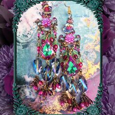 "This pair of Handmade Chandelier Earrings is made with Vitrial Rose teardrop jewels and sparkly Blue helix crystal beads.  Fuchsia AB Czech glass roses and hand-wrapped bead charms add loads of colorful detail. They're a delicate fantasy design with a pretty sparkle! The teardrop jewels are a vibrant Mint Green with Magenta edging.  Pierced with french wires  clip-ons or posts, just select from the pull-down menu.  Choose from the long or short version.  The short is seen in the last 2 images. Crystal Jeweled Chandelier Earrings Gift, Bohemian Jeweled Crystal Dangle Earrings, Jeweled Dangle Chandelier Earrings, Bohemian Crystal Chandelier Drop Earrings, Jeweled Chandelier Dangle Earrings For Celebration, Bohemian Jeweled Dangle Chandelier Earrings, Bohemian Crystal Chandelier Earrings, Bohemian Jeweled Chandelier Earrings As Gift, Pink Jeweled Dangle Chandelier Earrings