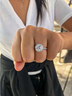 a close up of a person's hand with a ring on their finger