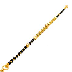 Weighing 4.3 grams, this 22k gold bracelet showcases a graceful yet jazzy design with black bead accents set against a radiant yellow gold finish. The 7.2-inch length, coupled with adjustable 0.6-inch links, ensures a perfect fit for any wrist. Secured by a hook lock, this bracelet offers a beautiful blend of traditional charm and modern flair, making it a versatile piece for both everyday wear and special occasions. PRODUCT DETAILS Gold Purity(karat): 22k Item Weight(grams): 4.3 Item Finish: Ye Black Bracelets For Festivals, Black Festive Bracelets For Festivals, Black Bangle Bracelets For Festive Occasions, Festive Black Bangle Bracelets, Festive Black Bangle Bracelet, Black 22k Gold Jewelry With Round Beads, Traditional Gold Bracelets With Black Beads, Adjustable 22k Gold Bracelet, Adjustable Yellow Gold Bracelet For Festive Occasions