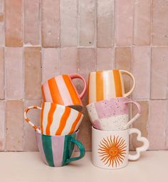 three coffee mugs sitting next to each other on a counter