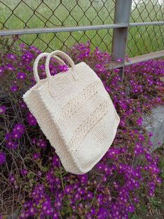 "This bag, which has an off-white color knitted from paper rope, is just for you. This handmade bag is knitted using a star pattern. It is big enough to hold all your belongings and has a separate pocket for the phone. This bag is light and soft, and a magnetic apparatus is used. Use it yourself or gift it to your loved ones. You will have made a difference. width : 12 inch (30 cm) length : 14 inch (35 cm)  You can contact me for any questions. I will reply you as soon as possible. \"Colorful Wo White Hand-knitted Tote Bag, White Hand-knitted Crochet Tote Bag, Eco-friendly White Crochet Straw Bag, Eco-friendly White Crochet Tote Bag, Handmade Basket-shaped White Crochet Bag, Yarn Bag, Medium Tote, Off White Color, Tote Bag Pattern