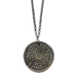 This unique and textural carved medallion is reversible to another carved pattern. It is reminiscent of a mandala. The meaning of mandala is Sanskrit for "circle." A mandala has a concentric structure, offering balancing visual elements. The purpose of a mandala is to serve as a tool to help harmonize and bring about unity, to absorb the mind so that the chatter stills and higher consciousness can be reached. Made of sterling silver on an oxidized, adjustable 16-18" sterling chain. Artisan Stamped Round Pendant Necklace, Artisan Etched Round Pendant Necklace, Artisan Carved Medallion Necklace, Carved Medallion Amulet Necklace, Bronze Medallion Necklace With Oxidized Finish, Large Brass Medallion Pendant Necklace, Amulet Style Medallion Necklace With Large Pendant, Symbolic Brass Medallion Necklace, Artisan Medallion Necklaces With Oxidized Finish