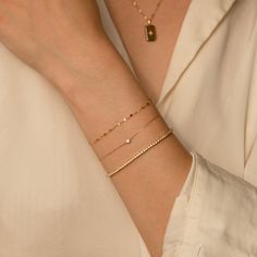 The Twisted Lace Chain Bracelet is an absolute must-have for your wrist. It’s dainty and adds just the right amount of feminine sparkle you have been looking for. If you’re looking for a bracelet you can wear every day - you've found it! It looks amazing on its own and dainty enough to pair with your other favorite bracelets. Crafted of 14k solid gold so you can wear it 24/7 - even to the gym, shower, and to sleep. This bracelet is a sparkly treasure that you'll never want to take off! DETAILS 1 Solid Gold Bracelet, Accessory Ideas, Minimal Ring, Types Of Gold, Dainty Bracelet, A Bracelet, 2025 Vision, Dainty Bracelets, Jewelry Photography