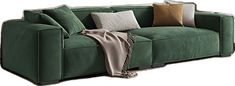 a green couch with pillows on it and a blanket draped over the armrests