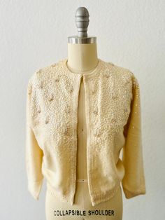 Vintage 50s Chantilly Cream Angora cardigan-Iridescent sequin beaded with Tassels-Hook and eye front closure-3/4 sleeve with silk lining Size:  XS, S Condition:  Good vintage condition, collar has been reinforced with sewn ribbon Elegant Sequin Sweater, Elegant Sequined Sweater For Fall, Elegant Sequined Cardigan For Fall, Elegant Winter Cardigan With Sequins, Fitted Spring Sweater With Sequins, Spring Fitted Sweater With Sequins, Elegant Spring Cardigan With Sequins, Elegant Sequined Cardigan For Spring, Elegant Spring Sequin Cardigan