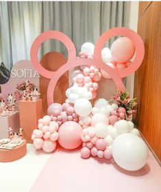 a table with balloons, cake and decorations on it