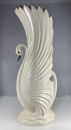 a white swan sculpture sitting on top of a table