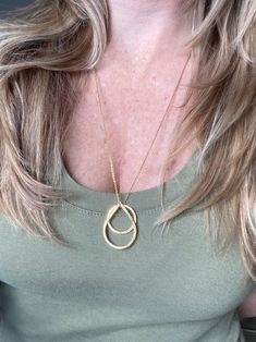 "Looking for a simple, but beautiful geometric necklace that is great for layering? Here it is! This handmade necklace is made from a circle shaped charm and a teardrop shaped charm strung through a delicate chain. The photos show this necklace at 24\", but custom lengths are always welcome! This unique necklace is perfect for anyone loves accessorizing with on trend, modern or minimalist jewelry. Made from high quality 16k gold plated brass. It has an effortless chic vibe to it and is great for Minimalist Teardrop Chain Necklace With Adjustable Chain, Everyday Teardrop Charm Necklace With Delicate Chain, Dainty Teardrop Necklace For Layering, Dainty Teardrop Pendant Necklace For Layering, Modern Long Necklace With Delicate Chain, Delicate Teardrop Pendant Charm Necklace For Everyday, Minimalist Charm Necklace With Teardrop Pendant, Minimalist Long Drop Necklace With Clavicle Chain, Minimalist Charm Necklace With Delicate Chain And Oval Pendant