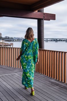 Make a statement with our breezy Biscayne Bay Caftan. This exquisite garment is more than just a piece of clothing; it's a celebration of fabric in all its glory. Crafted with generous amounts of fluorescent lime green and electric turquoise rayon georgette and lots of love, this piece offers an airy fit designed to drape beautifully on all body types. Whether worn poolside for a day at the cabana or layered and adorned with your favorite accessories for a glamorous evening affair, it's a versat Green Spring Cover-up For Beach Party, Green V-neck Beach Dress For Vacation, Green V-neck Beachy Maxi Dress, Green V-neck Kaftan With Vibrant Print, Green V-neck Cover-up For Beach Season, Tropical Green Kaftan For Beach Cover-up, Vibrant Green Vacation Dress, Green Breezy Maxi Dress, Vibrant Green Dress For Vacation