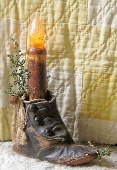 an old pair of boots with a candle in the middle