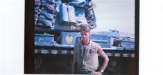 a man standing in front of a large tank