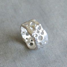 "This delicate organic shaped ring/ band is fully handmade of solid sterling silver with randomly arranged holes of different sizes. The irregular molten texture catches the light and sparkles. The model of each ring is carefully handmade of wax and cast in my home studio's foundry. The ring is elegant, not too chunky on the finger and very comfortable to wear. It is a sturdy, lasting piece of jewelry.  This gorgeous ring ring is ideal for everyday wear and it will also look amazing with a festi Chunky Statement Jewelry, Irregular Silver Ring, Wax Silver Jewelry, Silver Ring Chunky, Organic Silver Jewellery, Art Clay Silver Ring, Silver Handmade Ring, Wax Cast Ring, Silver Clay Ring Ideas