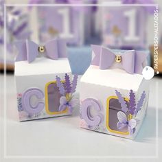 two small boxes with purple bows on them