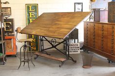 an old fashioned table and some chairs in a room with many signs on the wall