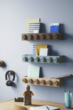 three wooden shelves with office supplies on them