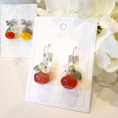 Discover the perfect accessory for fruit lovers with these adorable apple fruit earrings. Made with high-quality materials, these earrings are a fun and stylish way to show off your love for all things fruity. Perfect for adding a pop of color to any outfit, these earrings are sure to be a conversation starter wherever you go. These earrings are gently handmade by me, giving each item unique details and characters. Therefore, there are no two items exactly alike. Size: the bow tie stud style is Trendy Round Flower Earrings For Gift, Trendy Round Flower Earrings As Gift, Trendy Orange Flower Earrings As Gift, Fruit Design Drop Earrings As Gift, Trendy Red Flower Earrings For Gifts, Fruit Design Drop Earrings For Gift, Trendy Red Jewelry With Fruit Design, Trendy Red Fruit Design Jewelry, Cherry Colored Round Earrings For Gift