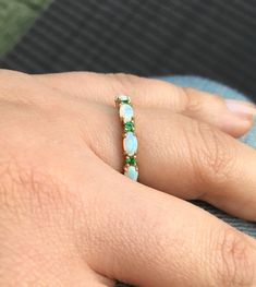 Opal and Emerald Half Eternity Matching Band Ring. Material: Solid Gold or PLATINUM Finishing: High Polished, Shiny Fit: Standard Width: 3.2 mm Height: 3 mm Setting: Prong Stone #1: Natural Opal Shape: Oval Size: 3mm x 5mm Quantity: 5 Opals Stone #2: Natural Emerald Quality: AAA Cut: Round, Diamond Cut Size: 2mm Quantity: 4 Emeralds This band will turn your Engagement Solitaire into a Sophisticated Wedding Set (Bridal Set). It will make your Solitaire Ring to pop out and look more eye catchy and Oval 14k Gold Eternity Band, Elegant 14k Gold Multi-stone Eternity Band, Fine Jewelry White Oval Eternity Band, Fine Jewelry Oval White Eternity Band, White Oval Eternity Band Fine Jewelry, Fine Jewelry Oval Jewelry For Marriage, Green Gemstone Eternity Band For Wedding, Yellow Gold Multi-stone Opal Ring For Wedding, Stackable Oval Rings For Anniversary