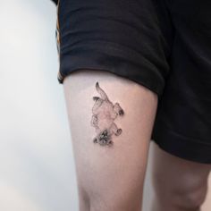 a person with a dog tattoo on their leg