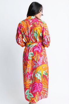 This Abstract Tropical Palm Shirt Dress features a tie waist and a colorful floral print that adds a touch of vibrancy to your wardrobe. With its button-up design and lining, this dress is both stylish and comfortable to wear. Colorful Floral Print Midi Dress For Beach, Multicolor Summer Shirt Dress For Beach, Collared Floral Shirt Dress For Beach, Vibrant Multicolor Print Midi Dress For Spring, Floral Print Midi Shirt Dress For Beach, Pink Floral Print Shirt Dress For Summer, Casual Multicolor Tie Waist Midi Dress, Casual Multicolor Midi Dress With Tie Waist, Multicolor Belted Dress For Spring