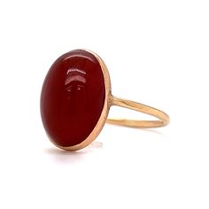 This stylish Victorian Bezel Set Carnelian Cocktail Ring features a cabochon cut red carnelian in polished 14 karat yellow gold. The center gemstone showcases a warm, crimson red hue. Set in a bezel on a dainty band. Perfect for signet ring & statement ring lovers. Timeless and chic. This antique cocktail ring would make a great gift for any loved one! Antique Cocktail Ring, Dainty Band, Red Carnelian, Crimson Red, Metal Shop, Shop Engagement Rings, Cocktail Ring, Signet Ring, Cocktail Rings