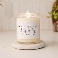 a candle that says, my wedding won't be lit without you on it