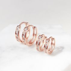 These Rose Gold Vermeil Huggie Hoop earrings will be your favorite everyday pairs. Our Huggies are true to size and will hug your ear perfectly. Great for smaller lobes or second piercings. 14K Rose Gold over Sterling Silver Cubic Zirconia Crystals Hypoallergenic, lead and nickel free Thickness 2mm Inside Diameter Sizes: 6.5mm, 9mm Snap closure #E008-RG Dainty Rose Gold Tarnish-resistant Huggie Earrings, Rose Gold Huggie Cartilage Earrings For Anniversary, Anniversary Rose Gold Huggie Cartilage Earrings, Everyday Hypoallergenic Rose Gold Cartilage Earrings, Dainty Rose Gold Hypoallergenic Huggie Earrings, Rose Gold Tarnish-resistant Dainty Huggie Earrings, Rose Gold Sterling Silver Huggie Piercings, Adjustable Rose Gold Huggie Earrings, Rose Gold Nickel-free Huggie Cartilage Earrings