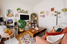 a living room filled with furniture and a flat screen tv