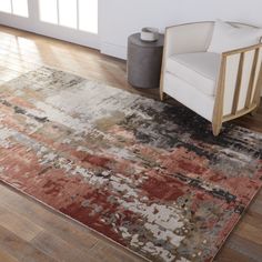 a chair and rug in a room with hardwood floors