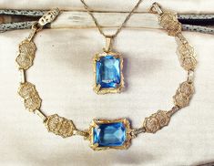 "I am SO thrilled to be offering an exquisite very rare Victorian/Edwardian circa 1930s -1940s era gold plated sapphire blue cut glass crystal pendant necklace AND/OR matching bracelet perfect for the Bride It's tough enough to find these antique filigree pieces anymore but to find pieces that are gold rather than silver, with blue stones, and then as a set is an extremely rare treat! The detailed gold plated ornate embossed pendant features a claw set rich sapphire blue high-quality cut glass c Art Deco Jewelry For Vintage Events, Art Deco Jewelry With Vintage Charm For Vintage Events, Art Deco Vintage Charm Jewelry For Formal Occasions, Vintage Charm Art Deco Jewelry For Formal Occasions, Formal Art Deco Jewelry With Vintage Charm, Heirloom Jeweled Bracelets For Wedding, Heirloom Jeweled Wedding Bracelets, Art Deco Jewelry With Vintage Charm For Anniversary, Art Deco Vintage Charm Jewelry For Anniversary