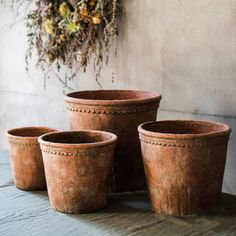 three clay pots sitting on top of a table