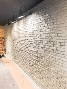 an unfinished room with white brick walls and scaffolding on the wall next to it