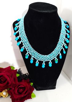 A handmade glass beaded necklace that is perfect for any occasion: parties, weddings, holidays, birthdays, anniversaries. All products are hand-crafted by my mother. Dimensions: - Length: 15.6 cm - Width: 14.5 cm - Height: 2.0 cm Lightweight, high quality with a hook as a clasp. Will respond to concerns and suggestions promptly. Shipping costs: Free Domestic Shipping. All orders are sent by air-mail with tracking number. Time of delivery: Estimated 2-5 days for domestic shipping; international may take 7-14 days. Feel free to check out our other similiar products! Link: https://www.etsy.com/shop/NurKnitsNKrafts Turquoise Round Beads Necklace For Party, Turquoise Necklaces With Round Beads For Party, Turquoise Beaded Chain For Party, Turquoise Beaded Jewelry For Party, Green Beaded Bridal Necklace Gift, Green Beaded Bridal Necklace, Handmade Turquoise Beaded Necklaces With Round Beads, Turquoise Beaded Necklace With Colorful Beads For Parties, Turquoise Faceted Beads Necklaces For Party