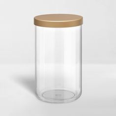 an empty glass jar with a gold lid