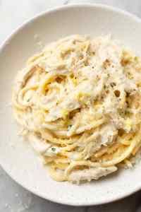 a white bowl filled with pasta and sauce