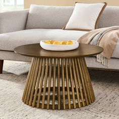 a living room with a couch, coffee table and pillows on the carpeted floor